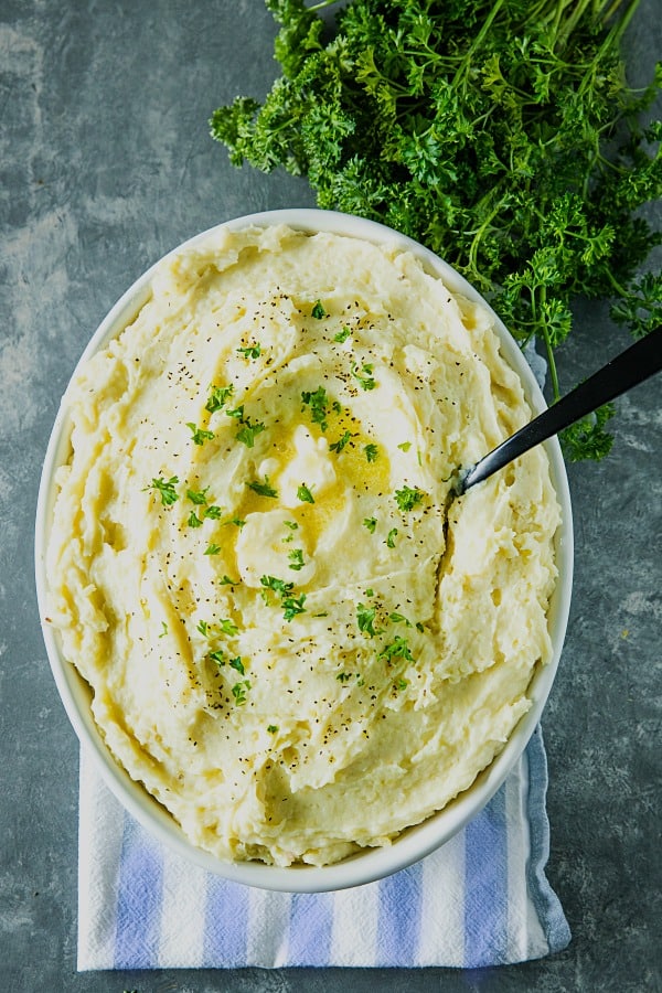 Make Ahead Mashed Potatoes are simple, creamy and so flavorful, made easy with baked potatoes. No peeling or boiling needed. Great for the busy holidays! #mustlovehomecooking
