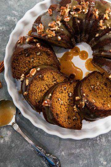 This Pumpkin Bundt Cake is irresistibly spiced, super moist and loaded with toasted pecans. An addictive fall treat you'll crave all year round! #mustlovehomecooking