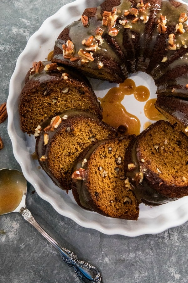 This Pumpkin Bundt Cake is irresistibly spiced, super moist and loaded with toasted pecans. An addictive fall treat you'll crave all year round! #mustlovehomecooking