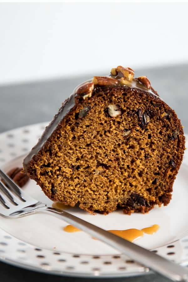 This Pumpkin Bundt Cake is irresistibly spiced, super moist and loaded with toasted pecans. An addictive fall treat you'll crave all year round! #mustlovehomecooking