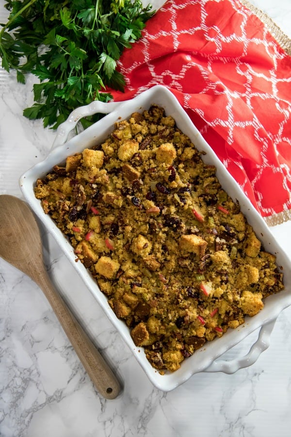 Pecan Apple Cornbread Stuffing made with toasted cornbread , crisp apples, pecans and cranberries, is a delicious sweet and savory dressing that'll be a hit on your holiday table. #mustlovehomecooking