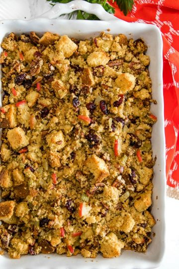 Pecan Apple Cornbread Stuffing made with toasted cornbread , crisp apples, pecans and cranberries, is a delicious sweet and savory dressing that'll be a hit on your holiday table. #mustlovehomecooking