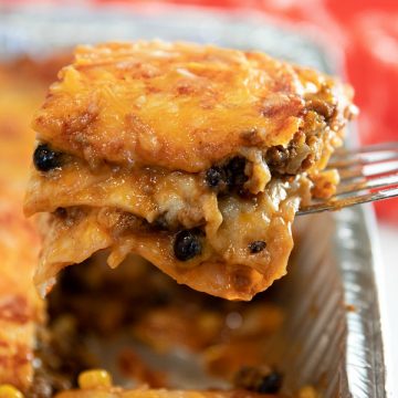 Easy Mexican Beef Lasagna - it's a Taco Tuesday favorite with layers of seasoned ground beef, tortillas, black beans, salsa and mounds of melted cheese. A freezer meal that's ready to just pop in the oven! #mustlovehomecooking