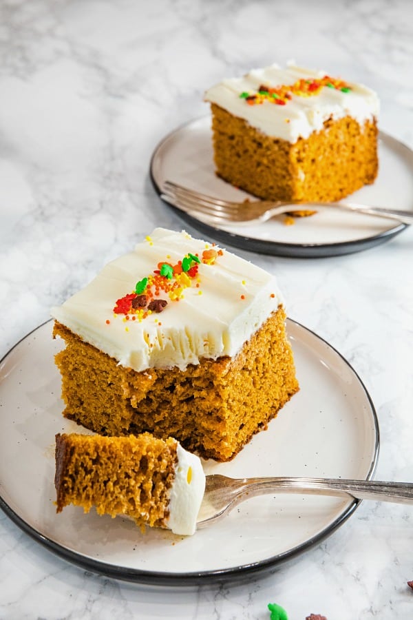 The Best Homemade Pumpkin Cake Ever - baked full of flavor with applesauce and spices then spread with a thick layer of tangy, smooth frosting.