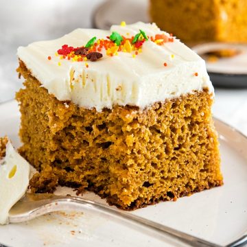 The Best Homemade Pumpkin Cake Ever - baked full of flavor with applesauce and spices then spread with a thick layer of tangy, smooth frosting.