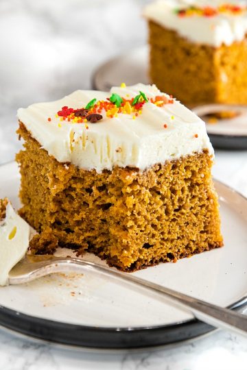 The Best Homemade Pumpkin Cake Ever - baked full of flavor with applesauce and spices then spread with a thick layer of tangy, smooth frosting.