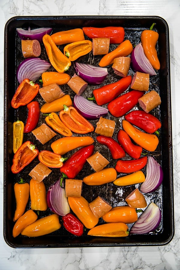 Delicious, versatile and fast, this Sheet Pan Smoked Sausage and Mini Peppers tossed with olive oil is an entire meal ready in 30 minutes!