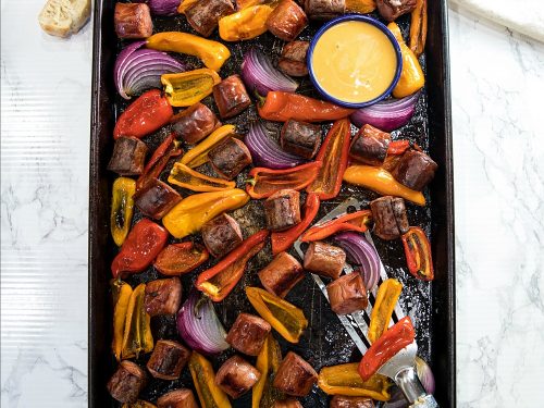 Delicious, versatile and fast, this Sheet Pan Smoked Sausage and Mini Peppers tossed with olive oil is an entire meal ready in 30 minutes!