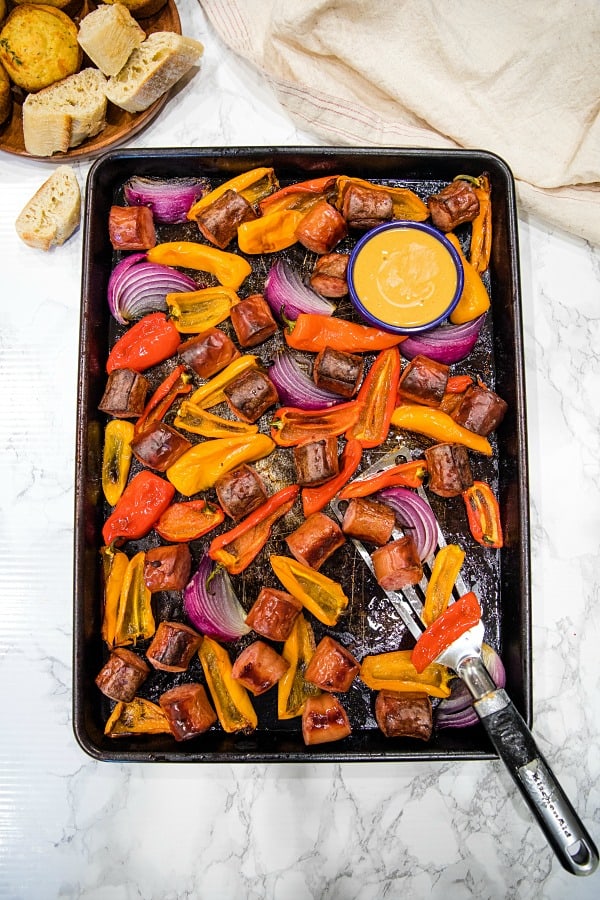 Delicious, versatile and fast, this Sheet Pan Smoked Sausage and Mini Peppers tossed with olive oil is an entire meal ready in 30 minutes! #mustlovehomecooking