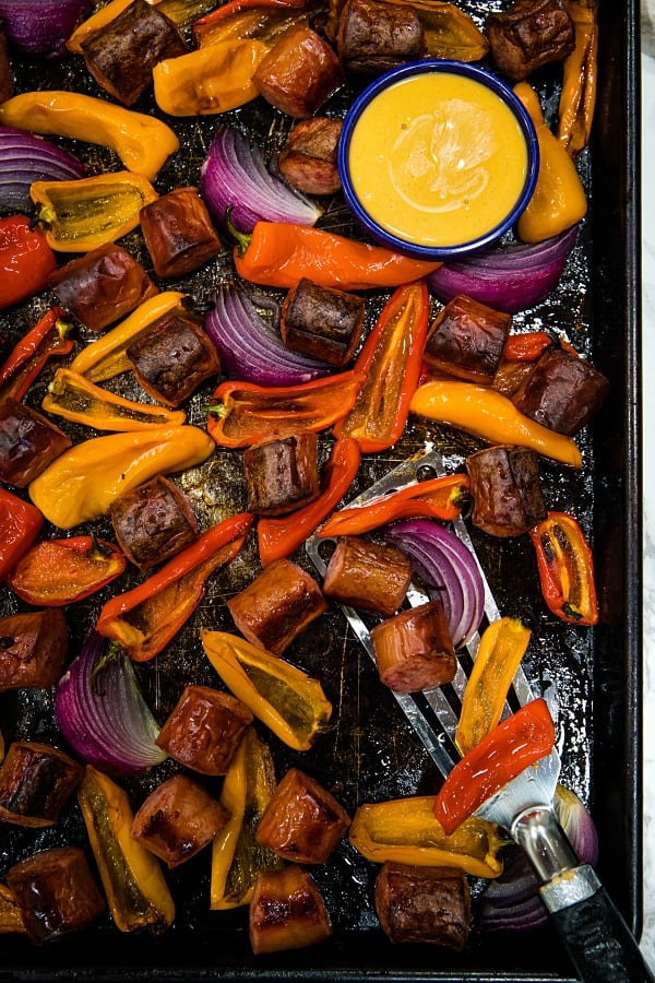 Delicious, versatile and fast, this Sheet Pan Smoked Sausage and Mini Peppers tossed with olive oil is an entire meal ready in 30 minutes!