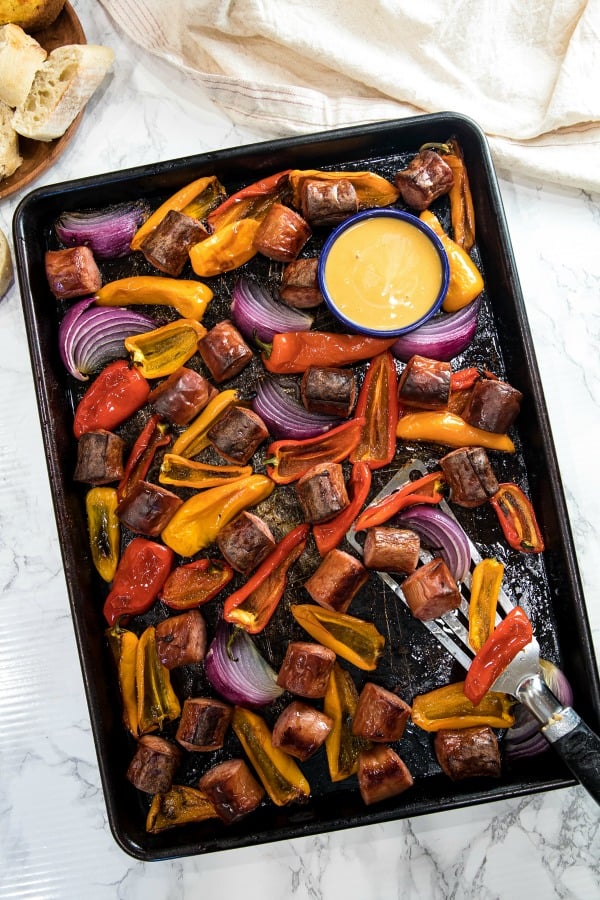 Delicious, versatile and fast, this Sheet Pan Smoked Sausage and Mini Peppers tossed with olive oil is an entire meal ready in 30 minutes!