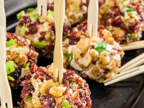 Festive bite size cheese balls take only minutes and are chock full of tangy goat cheese, cranberries and crunchy walnuts!
