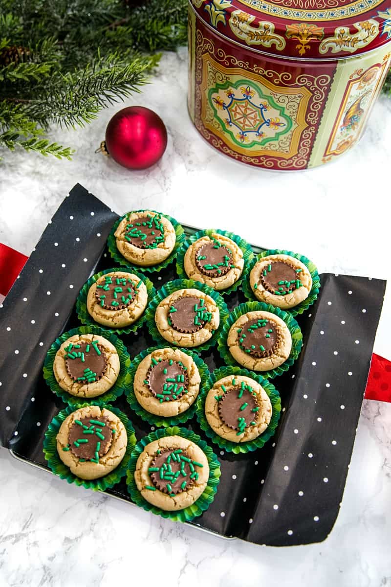 delicious holiday treats of peanut butter cookie dough baked into mini cups and stuffed with a mini chocolate peanut butter cup.