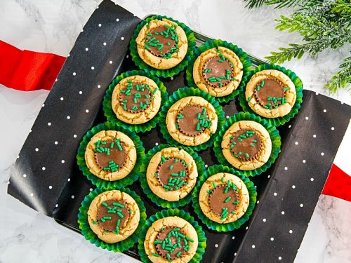 delicious holiday treats of peanut butter cookie dough baked into mini cups and stuffed with a mini chocolate peanut butter cup.