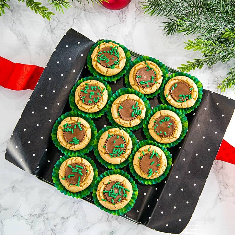 delicious holiday treats of peanut butter cookie dough baked into mini cups and stuffed with a mini chocolate peanut butter cup.