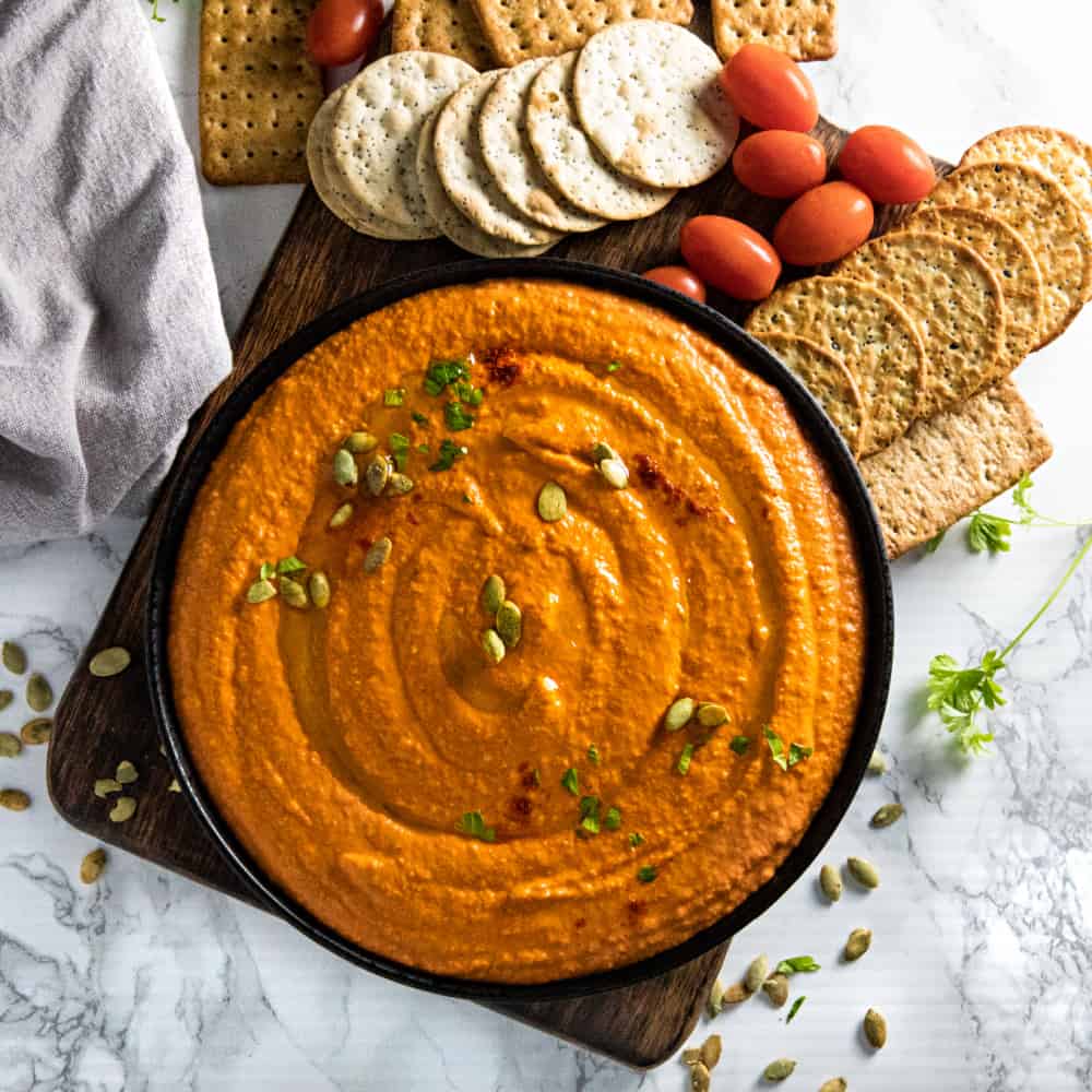 Easy Roasted Red Pepper Hummus recipe with tahini, chickpeas and spices is healthy, simple to make and so much tastier than store bought. Ready in 5 minutes! #nustlovehomecooking