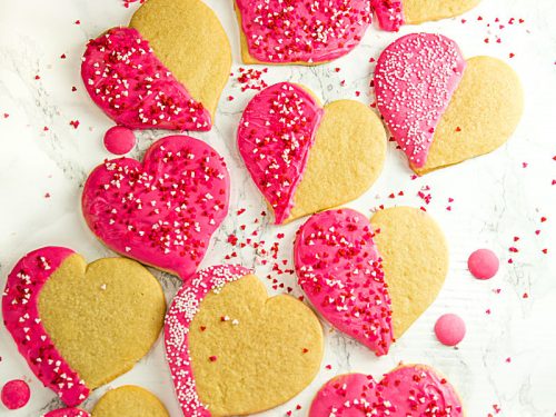 Crispy sugar cookies cut-outs decorated for your Valentine! Easy recipe for any occasion. #mustlovehomecooking