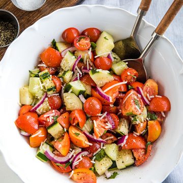 A super healthy side dish made with crisp cucumbers, tomatoes, red onion and parsley, then drizzled with a homemade sweet and sour dressing. #mustlovehomecooking