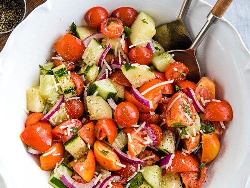 A super healthy side dish made with crisp cucumbers, tomatoes, red onion and parsley, then drizzled with a homemade sweet and sour dressing. #mustlovehomecooking