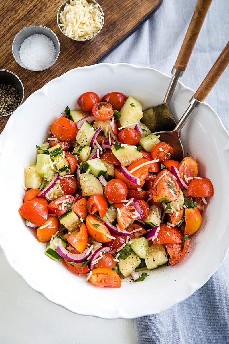 A super healthy side dish made with crisp cucumbers, tomatoes, red onion and parsley, then drizzled with a homemade sweet and sour dressing. #mustlovehomecooking