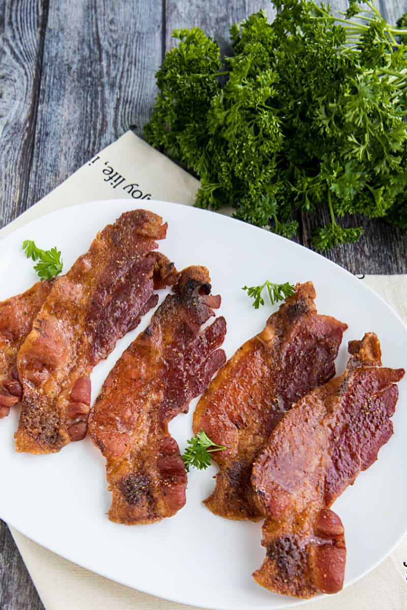 Spicy Sweet Oven Bacon, with brown sugar and spices, cooked perfectly crisp and delicious in the oven. So easy with no mess or splatter! #mustlovehomecooking