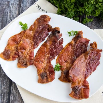 Sweet and spicy bacon cooked perfectly crisp and delicious in the oven. So easy with no mess or splatter! #mustlovehomecooking