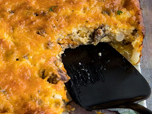 Hominy and Sausage Casserole is an easy, cheesy breakfast or supper bake. This hearty and nutritious comfort food can be made ahead too. #mustlovehomecooking