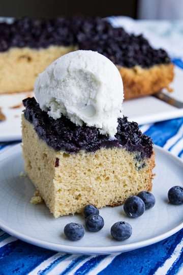 Made with fresh summer berries, this Easy Blueberry Upside Down cake is simple dessert anyone can make. The blueberries are caramelized under a layer of vanilla flavored cake, then flipped over for a thick blueberry topped cake with a perfect crumb. #mustlovehomecooking