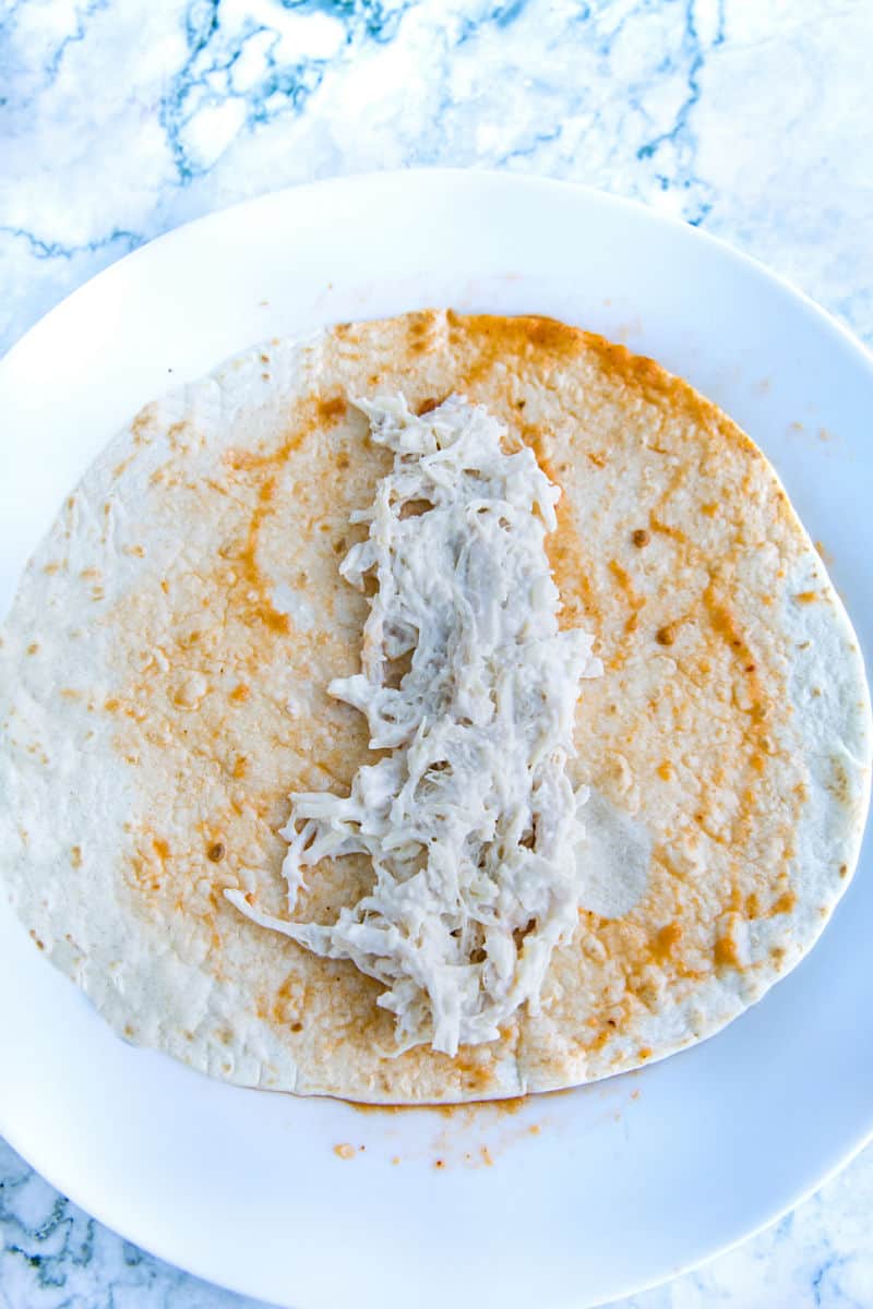 Enchalada chicken filling on flour tortilla