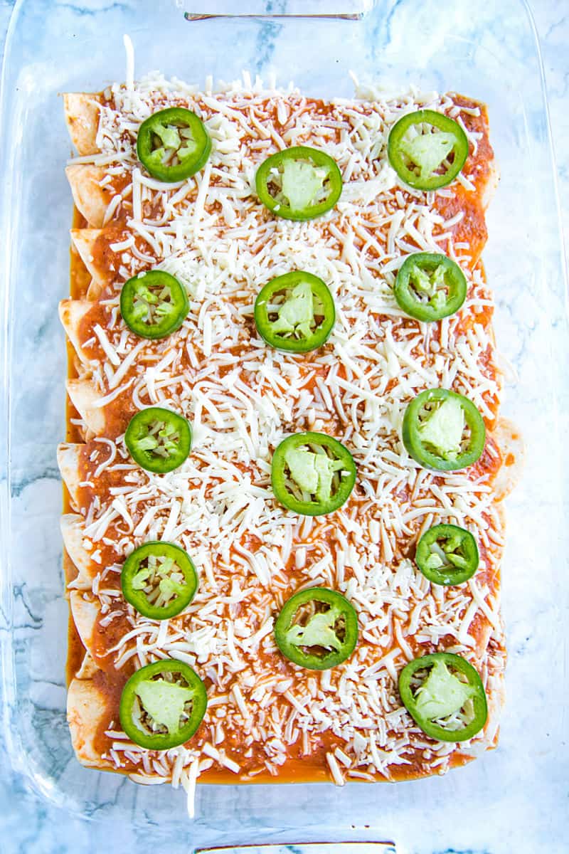 enchiladas ready to bake in glass baking pan