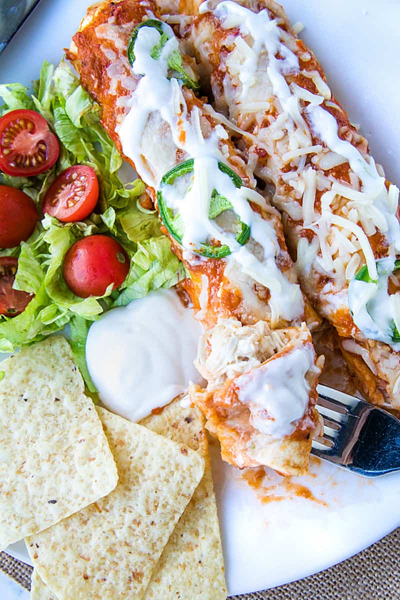 Chipotle Chicken Enchiladas made with shredded chicken, flour tortillas and a droolworthy chipotle enchilada sauce that takes this classic Mexican dish to a whole new level! #mustlovehomecooking