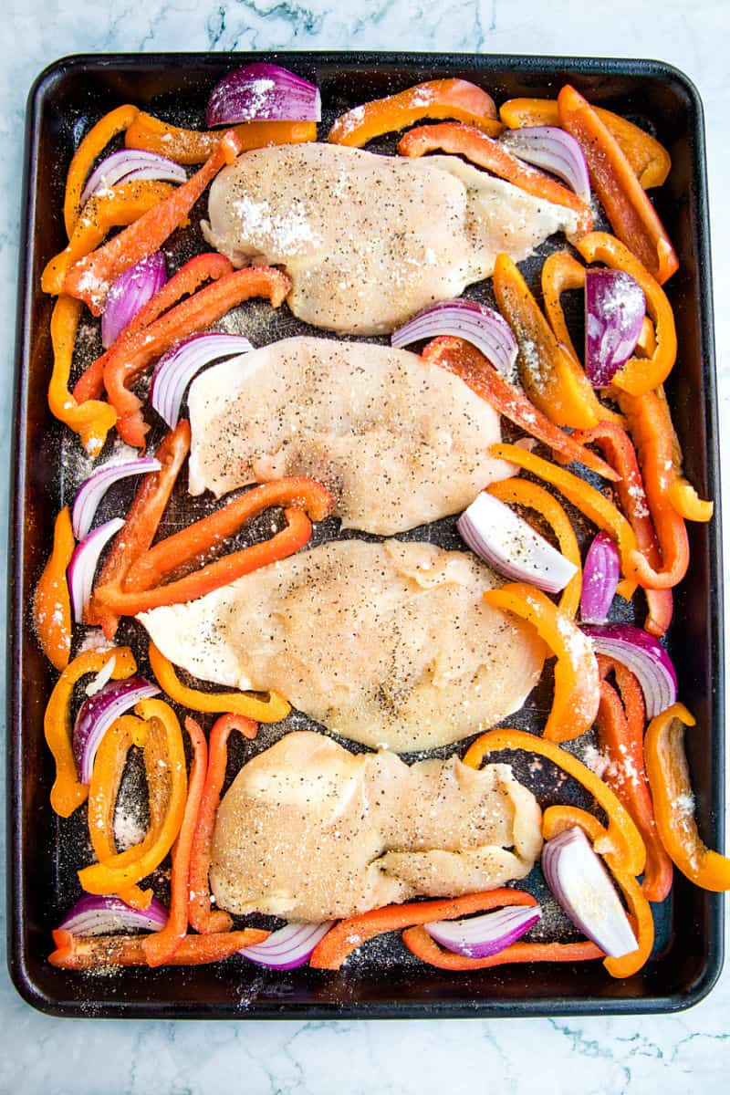 Chicken and vegetables ready for the oven on large sheet pan