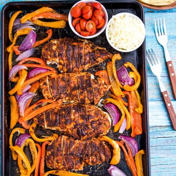 Classic chicken fajitas, with a twist, made easy on one sheet pan! An easy and delicious dinnertime favorite of juicy, adobo brushed chicken breasts, fresh bell pepper and onions all wrapped up in a soft flour tortilla. #mustlovehomecooking #mexicandinner #sheetpanrecipe