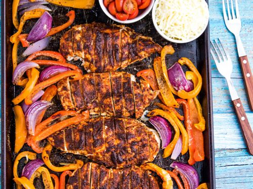 Classic chicken fajitas, with a twist, made easy on one sheet pan! An easy and delicious dinnertime favorite of juicy, adobo brushed chicken breasts, fresh bell pepper and onions all wrapped up in a soft flour tortilla. #mustlovehomecooking #mexicandinner #sheetpanrecipe