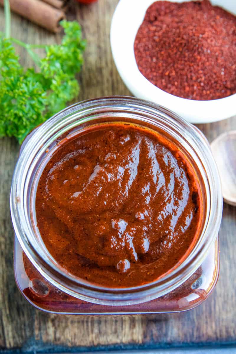 Mildly spicy homemade easy adobo sauce recipe is earthy, bursting with flavor and a classic Mexican cooking staple. Made with simple pantry ingredients. #mustlovehomecooking