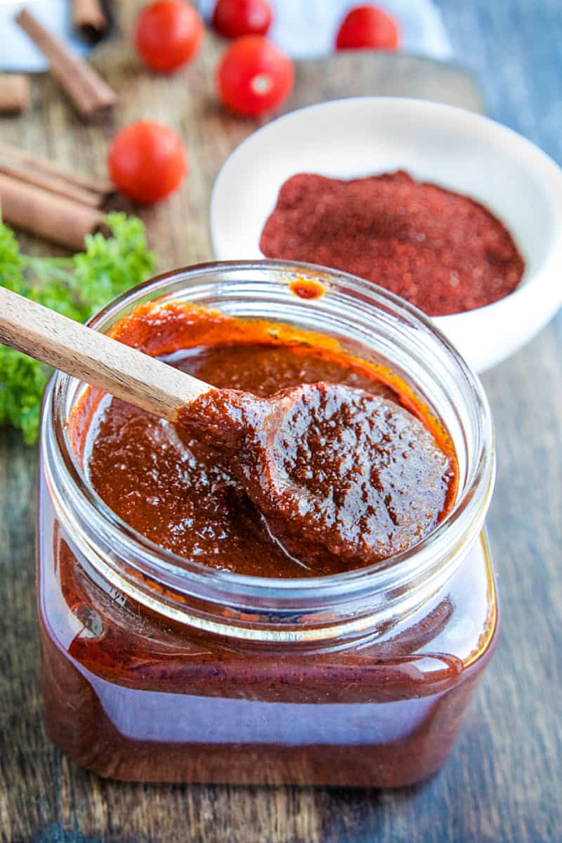 Mildly spicy homemade easy adobo sauce recipe is earthy, bursting with flavor and a classic Mexican cooking staple. Made with simple pantry ingredients. #mustlovehomecooking