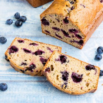 Blueberry Zucchini Bread is super simple and easy to make from scratch! This moist quick bread is made healthy with bursting blueberries, fresh zucchini and applesauce. #mustlovehomecooking