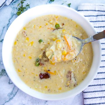 Homemade Corn Chowder is hearty, fresh and full of delicious flavors. Loaded with fresh corn kernels, tender red potatoes and crispy bacon, then finished with melting cheddar cheese and scallions. #mustlovehomecooking