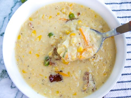 Homemade Corn Chowder is hearty, fresh and full of delicious flavors. Loaded with fresh corn kernels, tender red potatoes and crispy bacon, then finished with melting cheddar cheese and scallions. #mustlovehomecooking