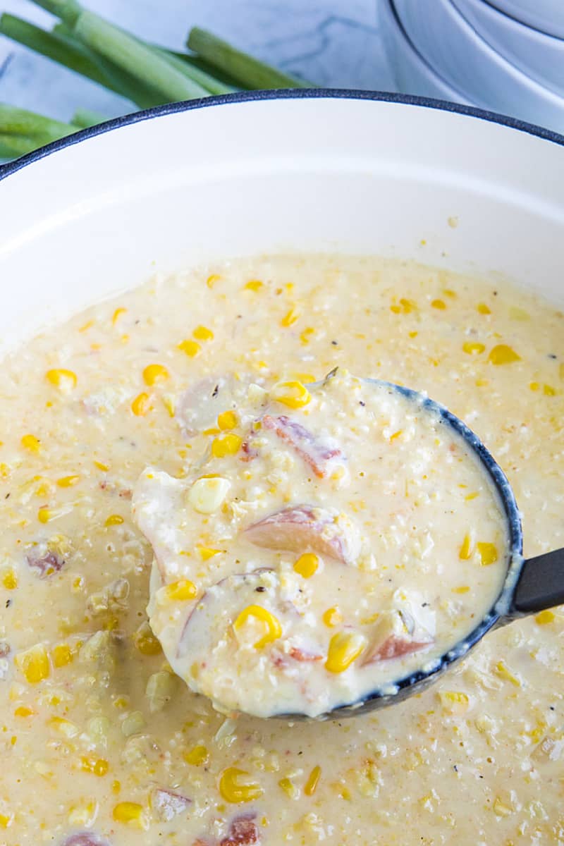 Homemade Corn Chowder is hearty, fresh and full of delicious flavors. Loaded with fresh corn kernels, tender red potatoes and crispy bacon, then finished with melting cheddar cheese and scallions. #mustlovehomecooking