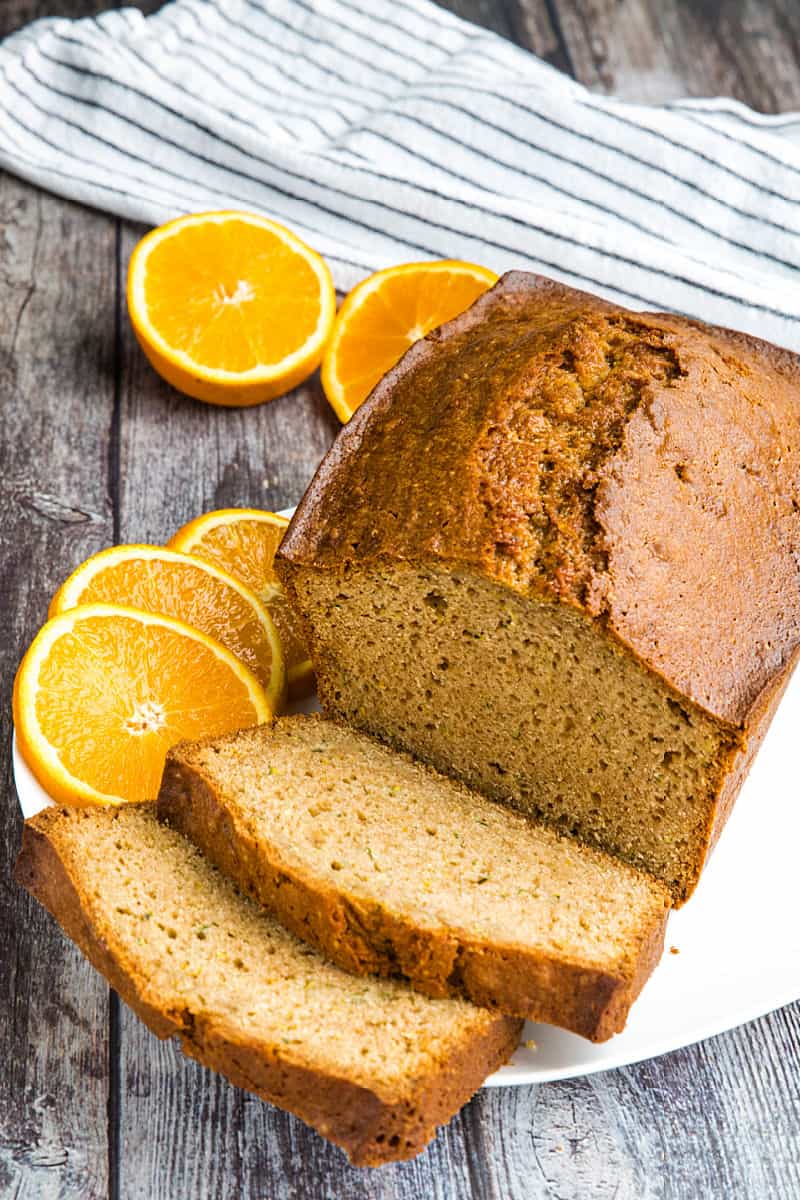 Best Ever Orange Zucchini Bread is simple and easy to make from scratch! This moist quick bread is made healthy with fragrant orange zest, fresh zucchini and applesauce. #mustlovehomecooking