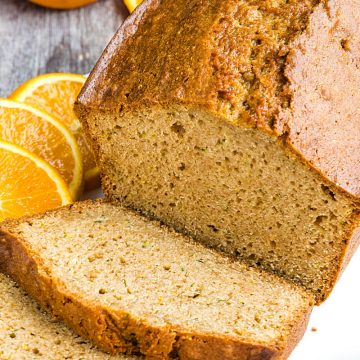 Best Ever Orange Zucchini Bread is simple and easy to make from scratch! This moist quick bread is made healthy with fragrant orange zest, fresh zucchini and applesauce. #mustlovehomecooking