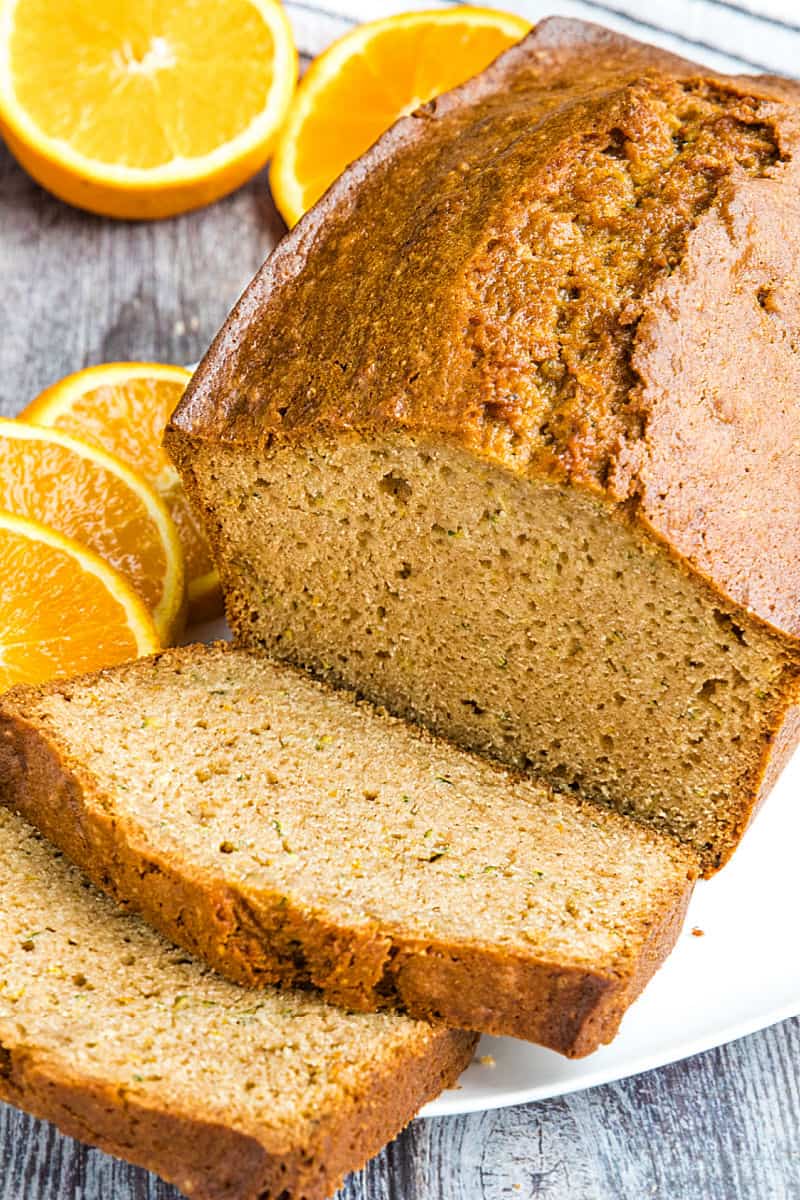 Best Ever Orange Zucchini Bread is simple and easy to make from scratch! This moist quick bread is made healthy with fragrant orange zest, fresh zucchini and applesauce. #mustlovehomecooking