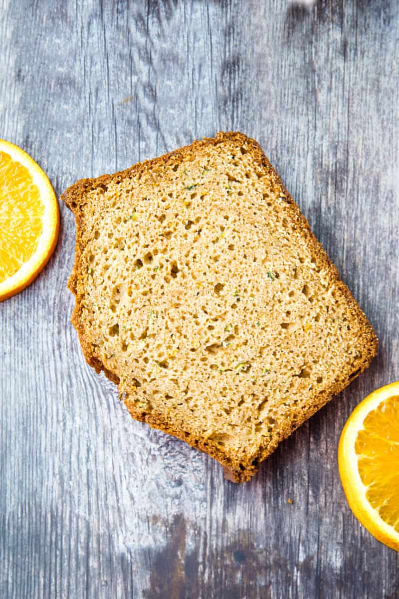 Best Ever Orange Zucchini Bread is simple and easy to make from scratch! This moist quick bread is made healthy with fragrant orange zest, fresh zucchini and applesauce. #mustlovehomecooking