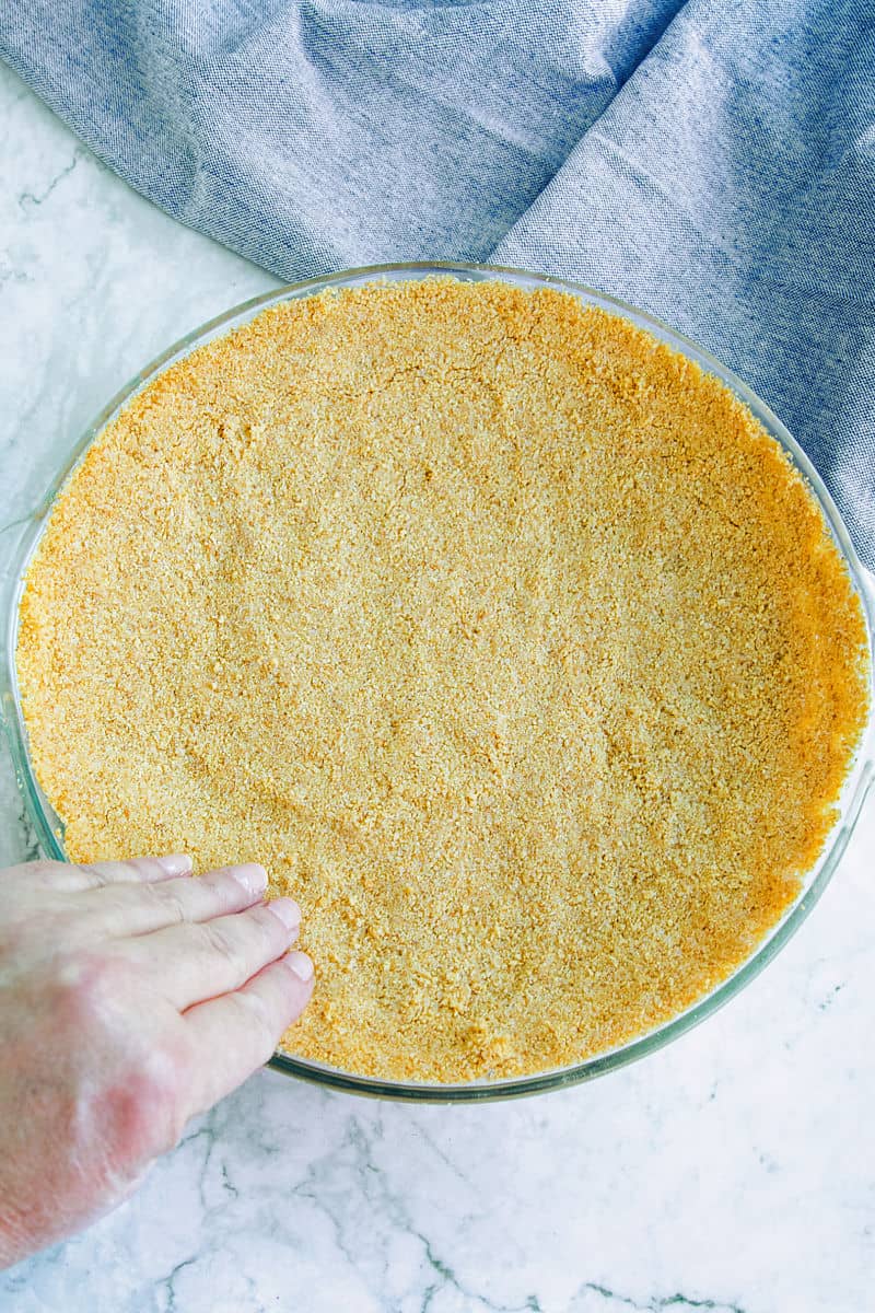Making a graham cracker crust in glass pie pan