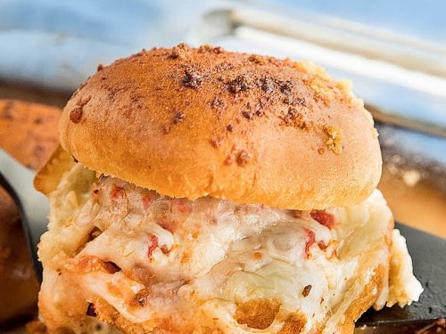 Hot and meaty Easy Garlic Meatball Sliders are oozing with melty cheese and garlic bread flavor. An irresistible game day and party snack! #mustlovehomecooking