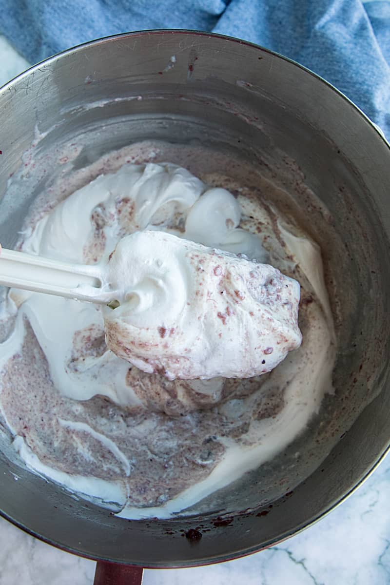 folding in whipped topping with rubber spatula in metal bowl #mustlovehomecooking