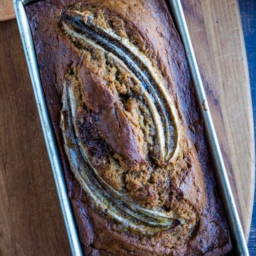 Easy "tried-and-true' homemade Banana Bread recipe that is the best way to use up over-ripe bananas. Made with brown sugar for a moist, dark loaf perfect to go with morning coffee or serve as dessert! #mustlovehomecooking