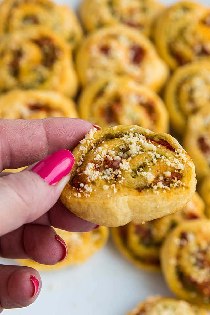 You'll LOVE these super Easy Pesto Crescent Pinwheels made with only 4 simple ingredients! Savory and delicious, this quick appetizer is perfect for any party or family gathering! #mustlovehomecooking