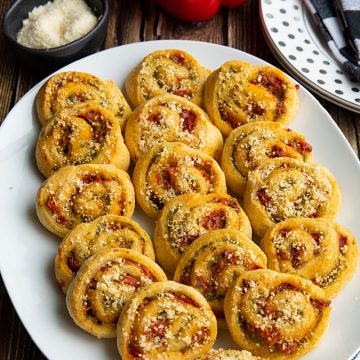 You'll LOVE these super Easy Pesto Crescent Pinwheels made with only 4 simple ingredients! Savory and delicious, this quick appetizer is perfect for any party or family gathering! #mustlovehomecooking